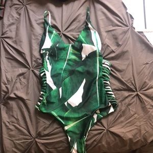 Green one piece swimsuit with low cut back